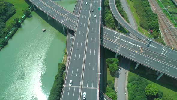 Aerial Drone Topdown Orbital View of Highway Multilevel Junction Road with Moving Cars at Daytime