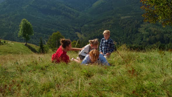 Family Lying Ground Green Meadow on Summer Vacation