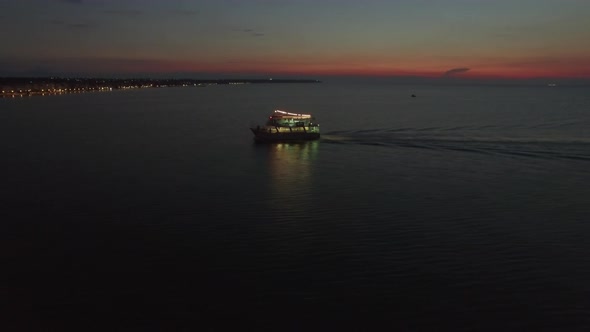 Aerial view of sailing touristic ship at night