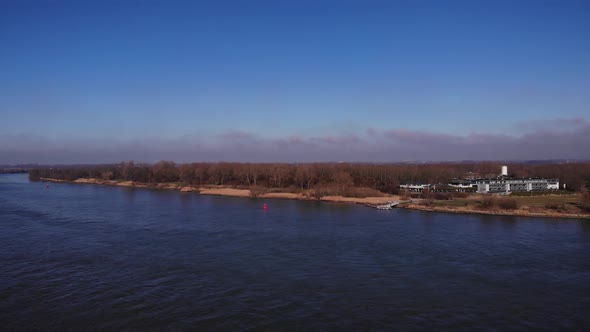 Water wave from a sail boat in a river. Aerial view on the water