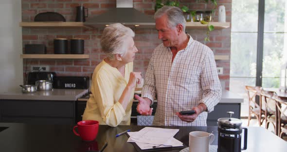 Senior Caucasian couple working together at home