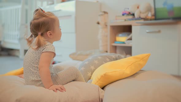 Happy Adorable Little Girl Watching Cartoon. Kids Leisure And Entertainment. Happy Childhood.