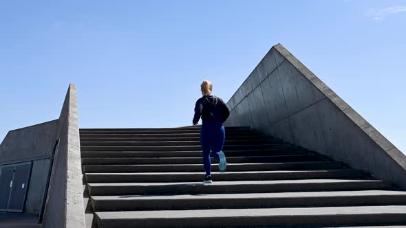 Attractive Young Woman, Running Up Stairs In Slow Motion, Stock Footage By Brian Holm Nielsen