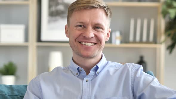 Portrait of Smiling Businessman Looking at Camera