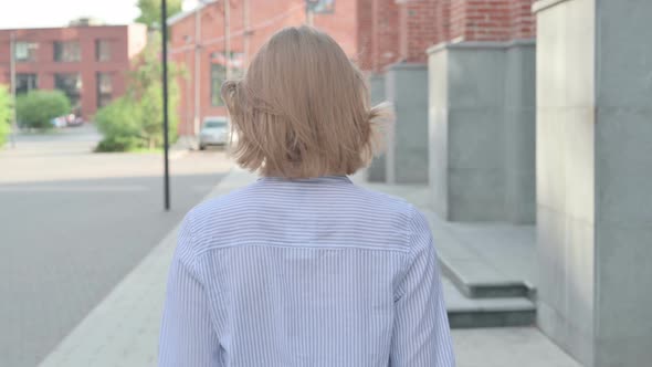 Close Up of Woman Walking in Street Back View