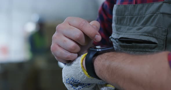 Worker Using Smartwatch in a Warehouse