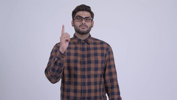 Young Bearded Indian Hipster Man Pointing Up