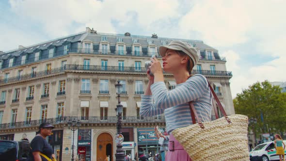 Young woman taking photo in Paris