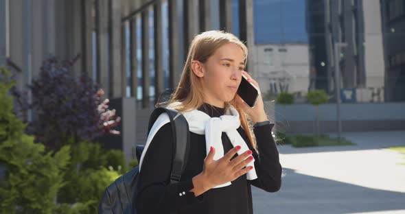 Blondie Has Pleasant Phone Conversation Outdoors Near Office Building