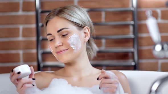 Portrait of Adorable Smiling Young Woman Posing with Mask on Face Taking Bath Looking at Camera