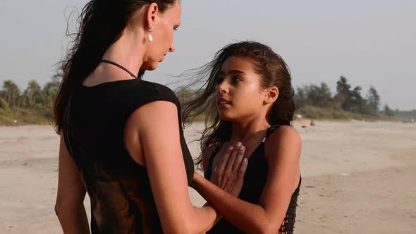 Mom and Daughter Stands Face to Face Hplding Hands and Getting Closer