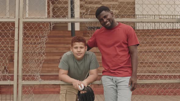 Portrait of Father and Son at Baseball Training