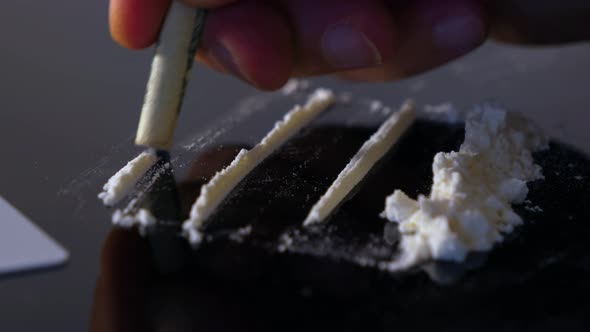 A rolled banknote snorting a line of cocaine powder. Drug Abuse. Sniffing Cocaine lines