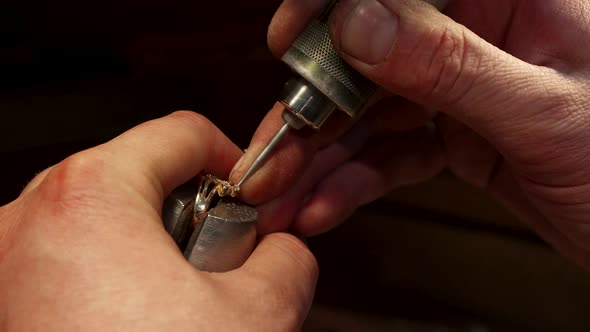 Man Putting Gemstone Into the Jewelry Item