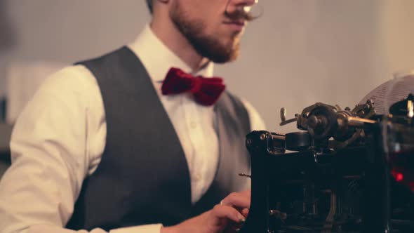 Young man typing on typewriter