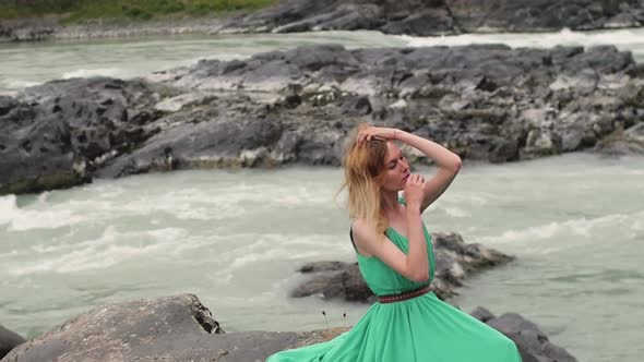 Young Woman in a Long Flowing Dress on the Background of the River and Mountains. Coloring Woman