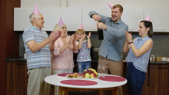 Multigenerational Family Members with Child Girl Kid Celebrating Birthday Party. Opening Champagne