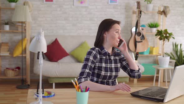 Young Woman with a Burn Scar on Her Face Talking on the Phone