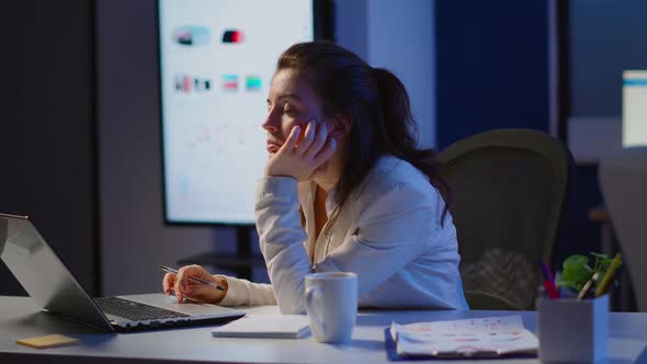 Exhausted Freelancer Sleeping in Front of Laptop Working