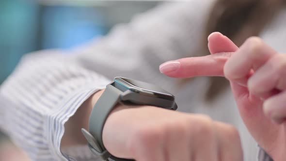 Close up of Young Woman using Smartwatch