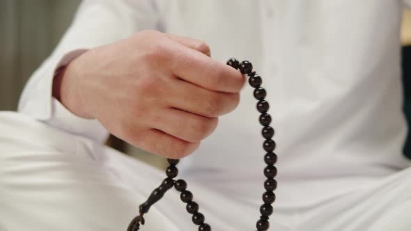 Man Praying with Rosary Beads Closeup Islamic Religion