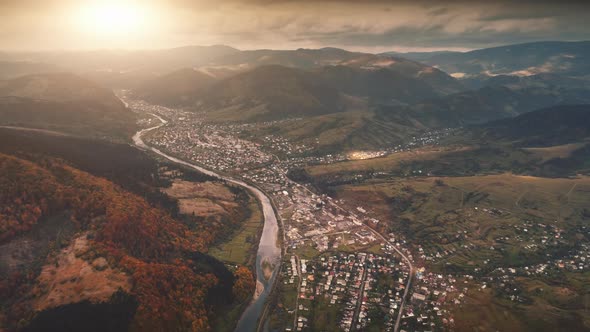 Drone Flight Over Autumn Village in Mountain Canyon