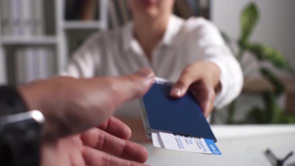 Getting Tickets At A Travel Agency, Agent Girl Is Issuing Tickets For A Flight To Warm Countries