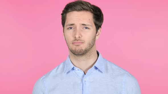 No, Disliking Young Man on Pink Background