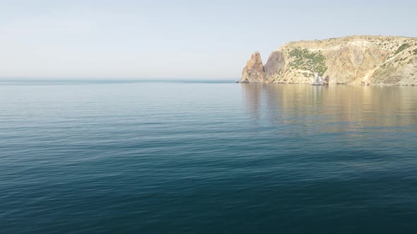 Aerial View From Above on Calm Azure Sea and Volcanic Rocky Shores