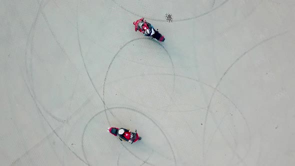 Top view of two professional motobikers racing highspeed on a road in a circle way. 