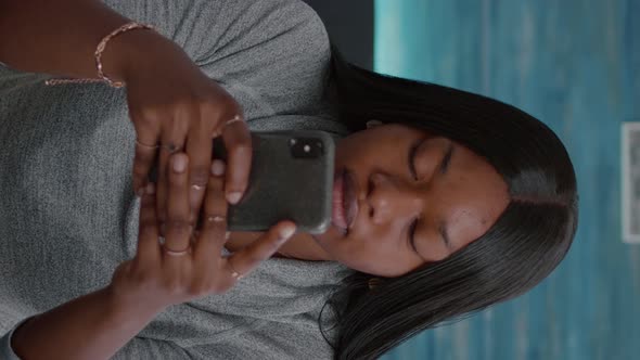 Vertical Video Black Student Looking Into Camera While Browsing Social Media Typing Message