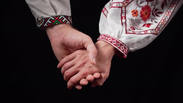 Young Ukrainian Couple in Embroidered National Shirts Holding Hands