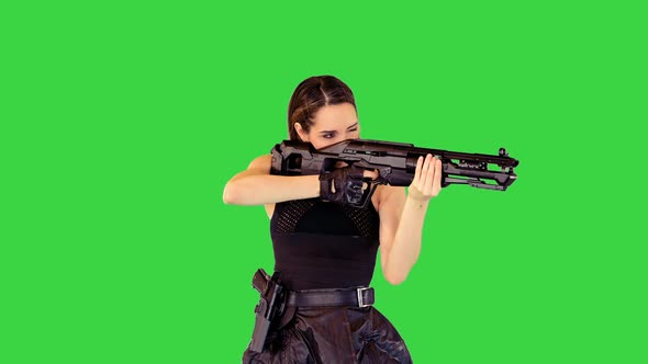 Girl with a Gun Searches for Aim and Makes a Single Shot on a Green Screen Chroma Key