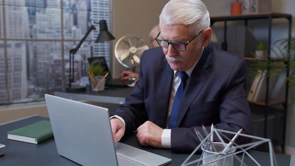 Elderly Man Boss Working in Office Room Rubbing His Chin Pondering Solution Doubting Question