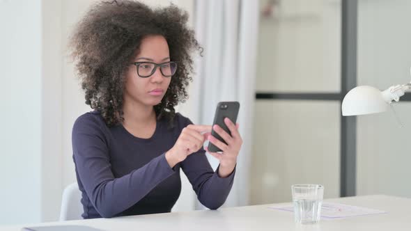 African Woman Using Smartphone at Work
