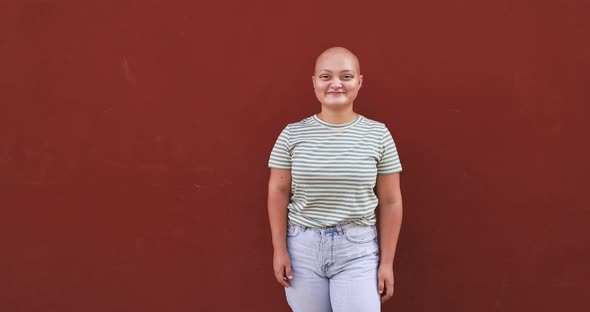 Bald girl posing and smiling in front of camera - Real people, diversity and female power