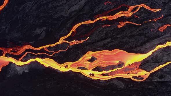 Glowing lava flow from a near by volcano streaming down a hill