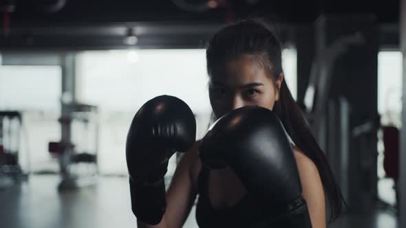 Female athletes practice kickboxing, practice boxing in the gym, enjoy a fitness lifestyle.