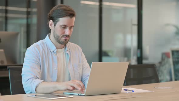 Mature Adult Man Leaving Laptop Going Away in Office