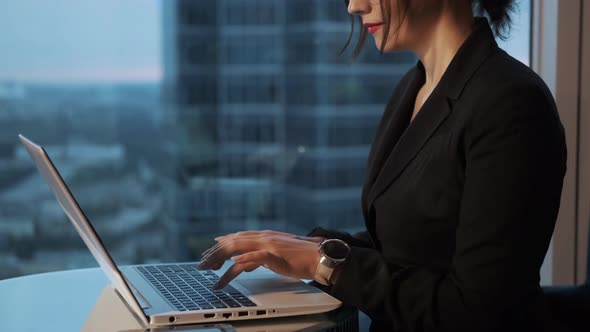 Business Woman Working in the Office Late in the Evening. Portrait of a Young Woman Working on a