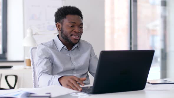 Businessman Having Video Chat on Laptop at Office 5