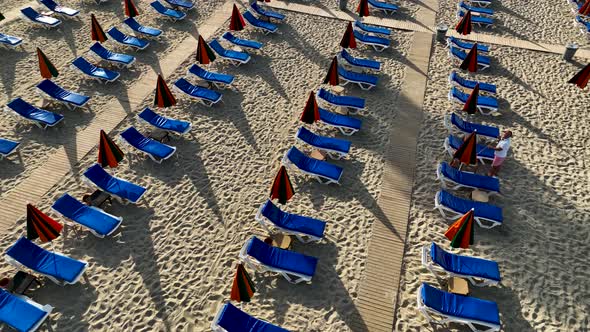 Empty sun loungers on the beach aerial view 4 K Turkey Alanya