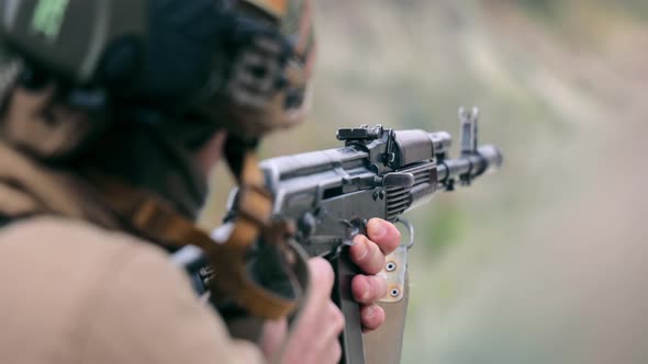 Military Shoots with a Machine Gun Close Up
