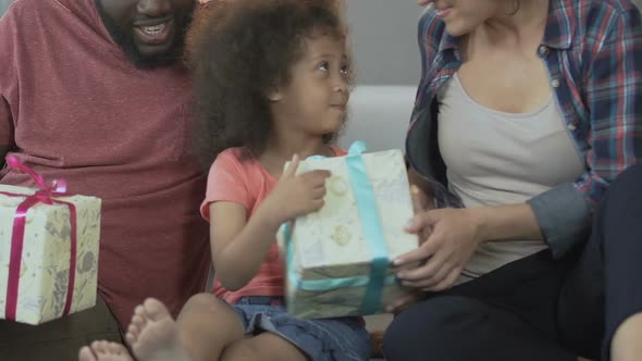 Daughter Receiving Presents From Parents, Birthday Celebration, Holiday Surprise