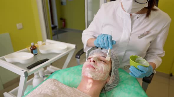 Woman Receiving Professional Skin Care Treatment in Clinic