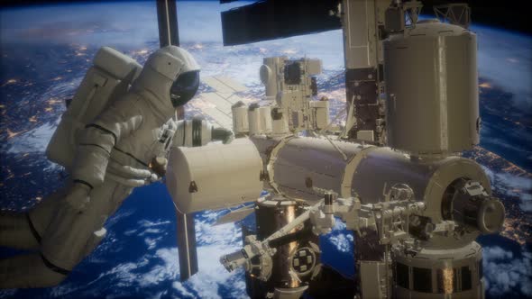 International Space Station and Astronaut in Outer Space Over the Planet Earth