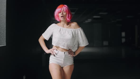 Portrait of Young Woman with a Pink Hairs Go Through the Hall and Looking at the Camera