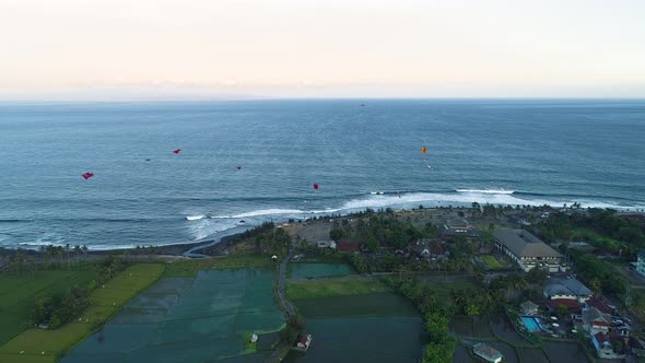 Kites Fly on the Ocean Shore Near the Rice Terraces in the Evening