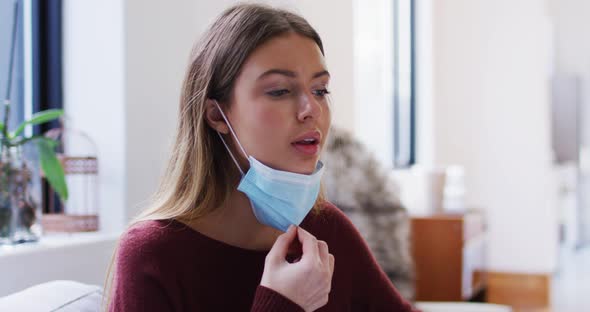 Woman pulling down face mask to breathe