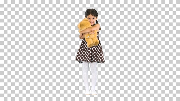 Little girl in polka dot dress hugging, Alpha Channel
